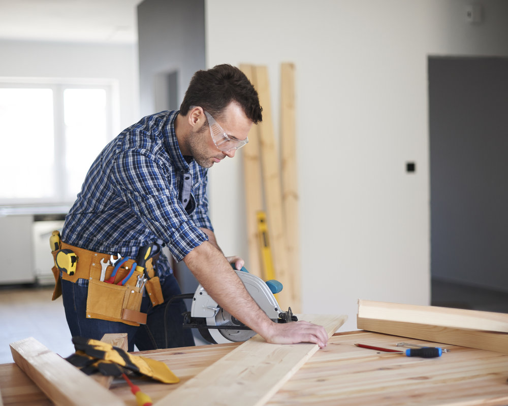 Olympus Builders carpenter cutting a wooden panel